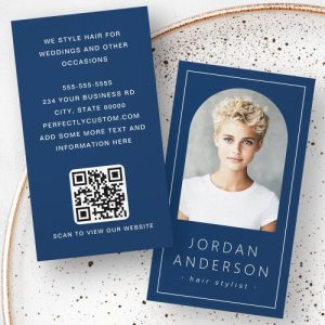 Customizable navy blue business card template with arch shaped personal photo, contact details, and QR code.