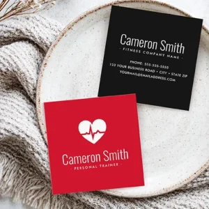 Double-sided square business card showing a vibrant red side with a white heart ECG pulse graphic and white headline text, beside a black reverse side displaying centered white contact text lines.
