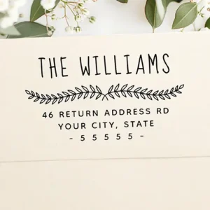 Custom stamp featuring a hand-drawn style family name header, a central botanical leaf sprig divider, and clean, text lines displaying a custom street address, city, state, and zip code.