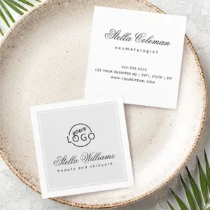 Front and back view of a square business card. The front features a light-grey panel with a white double-line border, custom logo spot, calligraphy name, and sans-serif title. The back is white with centered contact information placeholders.