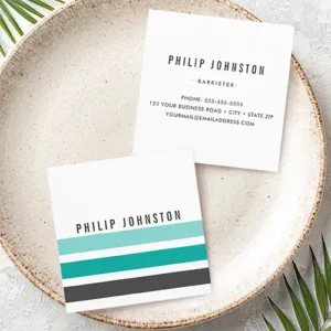 The front and back layouts of a square business card. The front shows a sleek white card with bold horizontal color blocks: aqua blue, teal, and charcoal, with customizable name text above. The back has a clean white layout with centered, customizable text fields for name, title, and detailed contact information in a clean, legible stack.