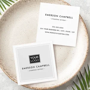 Front and back views of a customizable square business card. The front has a light gray background with a centrally aligned custom logo. Below are space for a custom name and job title. The back displays centrally aligned name and title at the top, and structured stacks of details (phone, address, website) below.
