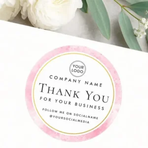 A custom branding label with a white center and pink watercolor rim, showing a "Thank You For Your Business" message and sections for brand personalization.