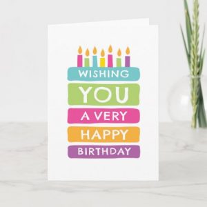 Happy birthday card featuring a colorful, layered cake with the text "wishing you a very happy birthday"
