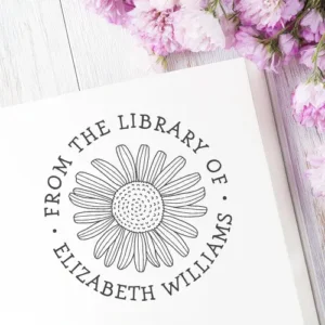 Circular floral library bookplate stamp with hand-drawn daisy illustration and customizable name and “From the Library Of” text.