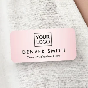 Soft pink plastic name pin with rounded corners displaying a custom logo, stacked uppercase custom employee name, and an italicized job title line.