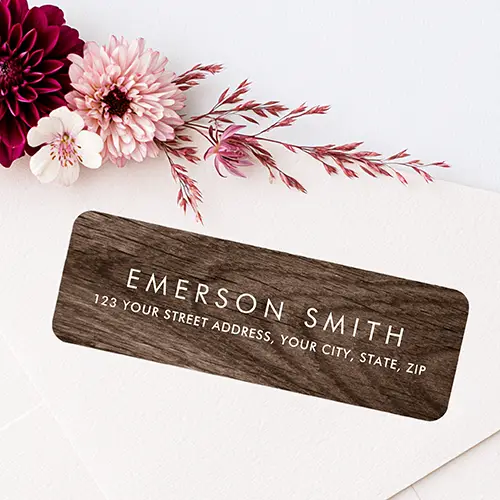 Rectangular return address sticker featuring elegant dark brown wood grain background with modern white uppercase name and address typography.