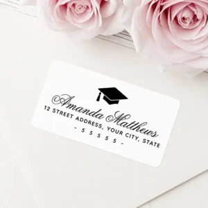 Rectangular white return address sticker featuring a central black graduation cap silhouette above elegant calligraphy cursive name typography and block address text.