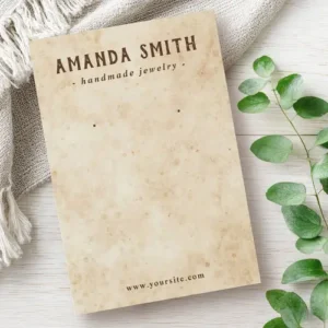 A two-sided rectangular earring display card with a printed rustic, aged-paper texture and professional typography for brand and contact details.