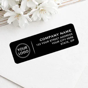 Rectangular address sticker with a black background featuring a custom logo on the left and white corporate address text on the right.