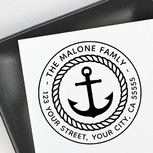 Round stamp design featuring a central ship anchor icon enclosed by a twisted nautical rope border and arched custom name and address text.