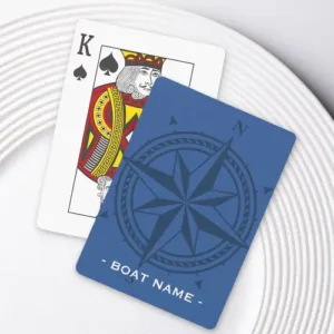 Playing cards featuring a large, tonal dark blue compass rose surrounded by a rope border and customizable text along the bottom edge on a deep blue background.