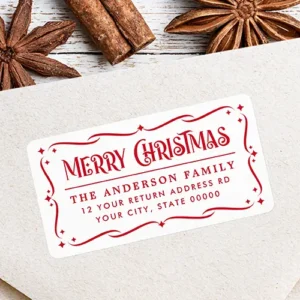 White rectangular return address sticker enclosed in a red filigree scrollwork frame with starbursts, featuring vintage "Merry Christmas" typography above a horizontal line divider and custom red address text.