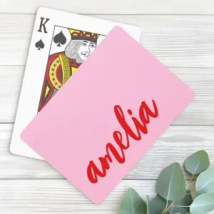 Playing cards featuring a solid, bright bubblegum pink background and your custom name printed vertically along the right edge in a bold, flowing red script font.