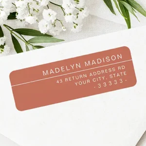 Horizontal terracotta brown self-adhesive address label featuring crisp white uppercase lettering, a thin dividing line, and right-aligned address details.