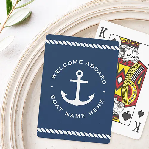 A rectangular custom playing card with rounded corners, featuring a solid deep navy blue background. White twisted rope patterns border the top and bottom edges. In the center, a large white anchor graphic is surrounded by arched text reading "WELCOME ABOARD" on top and a custom text placeholder on the bottom.