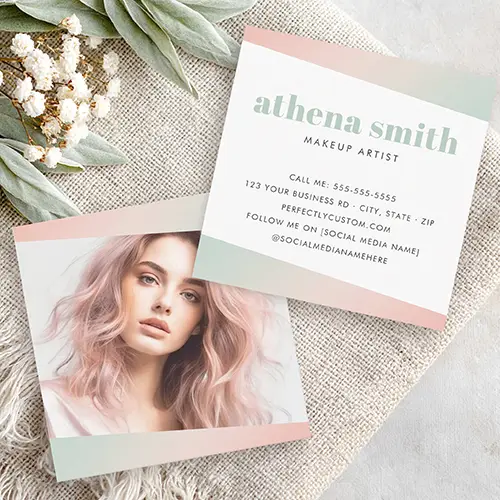 Chic square business card, perfect for makeup artists and beauty pros. The front features an angled custom photo placeholder within on-trend blush pink and mint green corner accents. The back provides comprehensive customizable fields for your name, title, and full contact details.