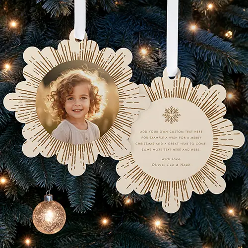 Double-sided snowflake paper ornament card featuring a custom photo frame encircled by a bronze sunburst pattern on one side and customizable holiday text with a snowflake icon on the reverse.