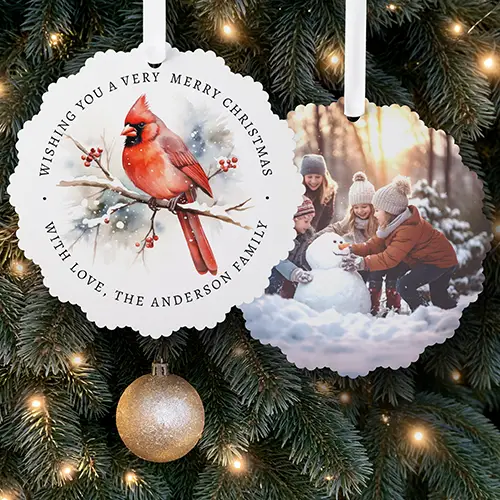 Scalloped round double-sided paper ornament card featuring a watercolor red cardinal on a snowy branch with arched holiday text on one side and a custom photo on the other.