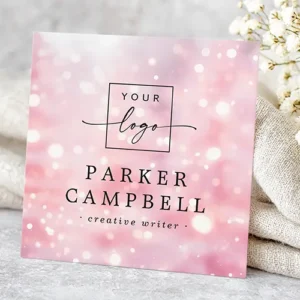 Customizable square business card template featuring a dazzling pink bokeh pattern, with fields for a logo, name, and comprehensive contact information.
