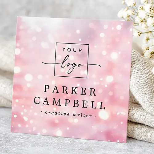 Customizable square business card template featuring a dazzling pink bokeh pattern, with fields for a logo, name, and comprehensive contact information.