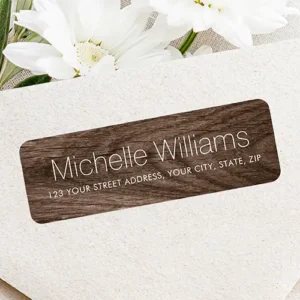 Horizontal dark brown wood texture self-adhesive label featuring crisp white sans-serif typography for a name above a single address line.