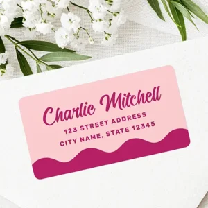 Rectangular light pink sticker displaying a magenta wavy bottom accent, magenta cursive script names, and two centered lines of address text.