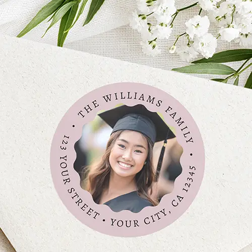 Round address sticker featuring a rose mauve border with curved serif typography surrounding a graduate's photo framed in a scalloped circle.