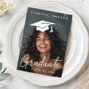 Flat vertical photo card displaying custom graduate portrait photography, white script typography, and a movable white graduation cap graphic overlay.