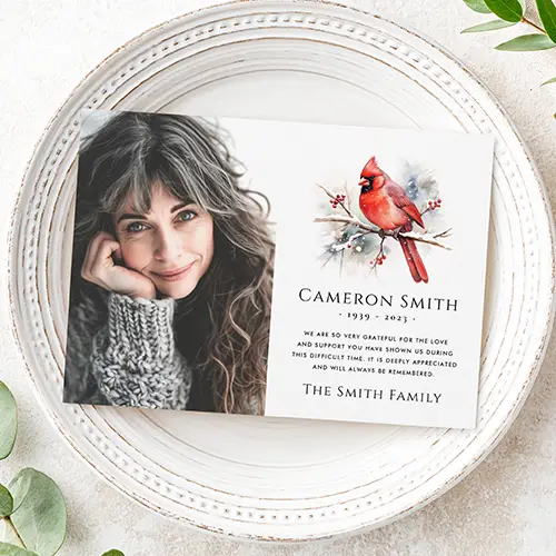 Horizontal flat memorial card featuring a portrait photo field on the left and a watercolor style red bird illustration above custom name, dates, and text on the right.