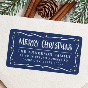 Rectangular navy blue return address sticker with rounded corners, featuring white scrollwork filigree, yellow starbursts, vintage "Merry Christmas" typography, and custom white address lines.