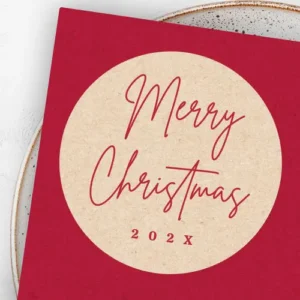 Round Merry Christmas sticker with printed kraft paper background, red handwritten script, and customizable “202X” year.
