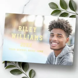 A graduation guest book featuring a full-bleed photo of a graduate on the front cover, with custom name and year in shimmering real foil.