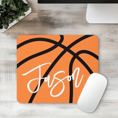 Custom basketball mousepad with orange basketball-inspired design, black curved seam lines, and personalized white name. Ideal for basketball players, sports fans, students, and coaches.