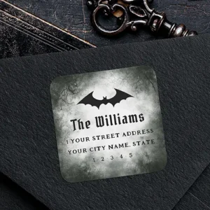 A square return address label featuring a black bat silhouette centered over a weathered grey background with gothic text and address lines.