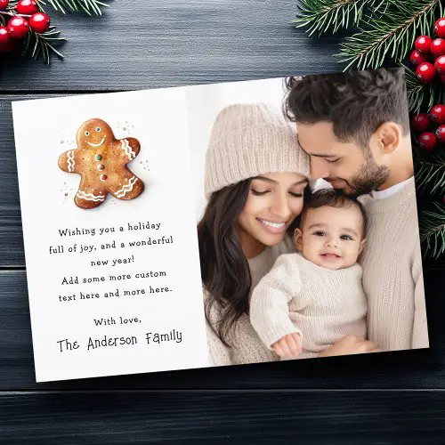 Personalized Christmas photo card featuring watercolor gingerbread cookie illustration, family portrait, and customizable holiday message with family name.