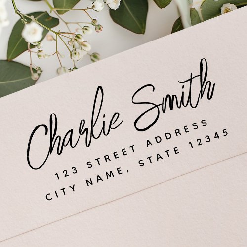 Custom elegant script return address rubber stamp with personalized name and modern text design.