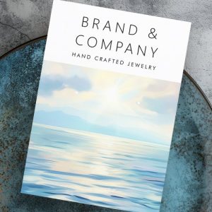 Custom seaside earring display cards featuring a tranquil sunrise over the ocean, brand name and contact info.