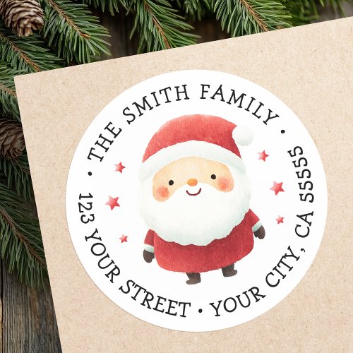 Round Santa Claus return address label with watercolor Santa in red suit, fluffy beard, and rosy cheeks. Surrounded by red stars, customizable family name and address in serif font. Perfect for Christmas cards, holiday invitations, and festive gift mail.