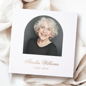 White memorial guest book with customizable real foil text, featuring a front cover arched photo frame, foil name and dates, and spine text In Loving Memory. Elegant design available in gold, silver, or rose gold foil.
