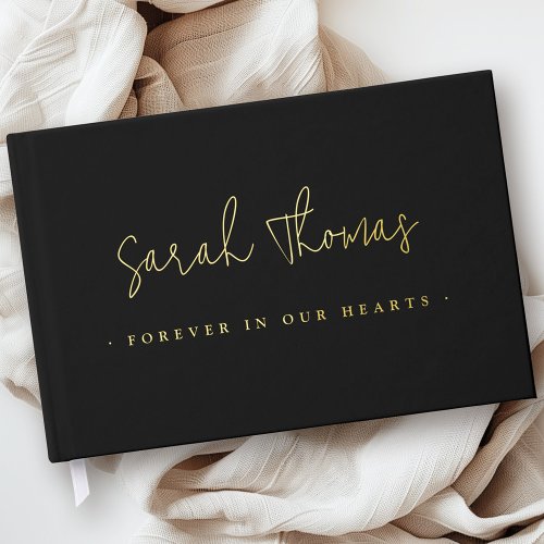 Custom real foil memorial guest book with black cover, elegant script name, and Forever in Our Hearts phrase. Personalize with foil in gold, silver, or rose gold, plus name and dates. Perfect funeral or celebration of life keepsake.