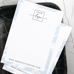 Customizable earring card with light blue brushstroke design, space for logo, website, and social media details.