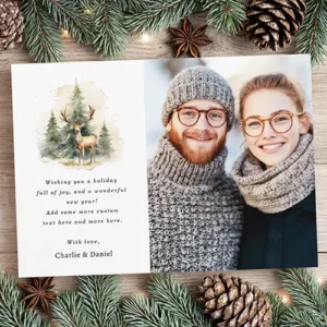 Flat holiday card displaying a white front panel with a watercolor deer illustration, customizable greeting text, and a vertical custom photo.