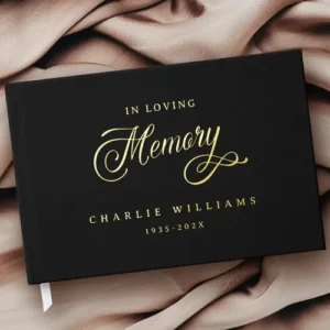 Black memorial guest book with real foil text “In Loving Memory,” personalized with name and dates in gold, silver, or rose gold foil. Elegant keepsake for funeral or celebration of life.