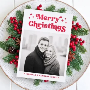 A vertical Christmas card featuring your custom photo. Above the photo is bold red 70s-style 'Merry Christmas' text with star icons. Below is personalized name text.