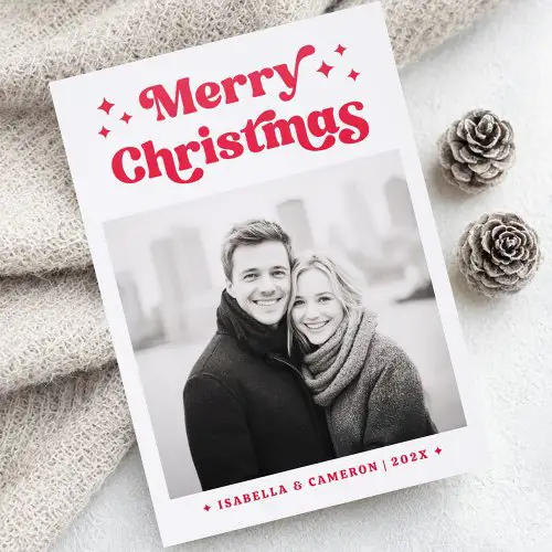 A vertical Christmas card featuring your custom photo. Above the photo is bold red 70s-style 'Merry Christmas' text with star icons. Below is personalized name text.