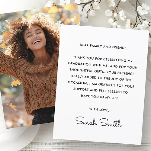 A double-sided flat graduation stationery card. The front side showcases a full-bleed vertical custom photo template that completely fills the layout out to its borderless edges. The reverse side features a minimalist, solid white background with a centered block of black, capitalized sans-serif text for a personalized message, rounded out at the bottom with an editable custom signature template written in a delicate flowing cursive script.