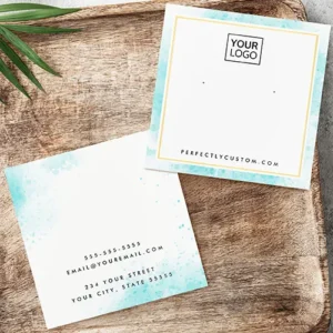 Double-sided square earring display card featuring an aqua turquoise blue watercolor wash border. The front displays a thin gold foil frame containing a logo placeholder, two printed dot hole guides, and a website URL. The back features centered text lines for phone, email, and address.