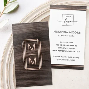 Elegant monogram logo photo minimalist dark wood foil business cards A two-sided vertical business card template. The front features a full-bleed dark wood background centered with a multi-bordered metallic rose gold foil frame enclosing two stacked letters. The reverse side features top and bottom dark wood accent bars with metallic foil lines and a white central text area with placeholders for a logo and contact information.