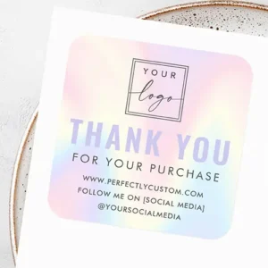A square self-adhesive business sticker with rounded corners, featuring a printed pastel rainbow gradient background in pink, lavender, and blue. The design includes a custom logo, large lavender "THANK YOU" text, dark gray "FOR YOUR PURCHASE" subtext, and three editable text lines for website and social media info.